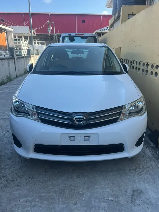 2012 Toyota Corolla Axio, white sedan for sale at Rahaman & Sons, Success — in stock