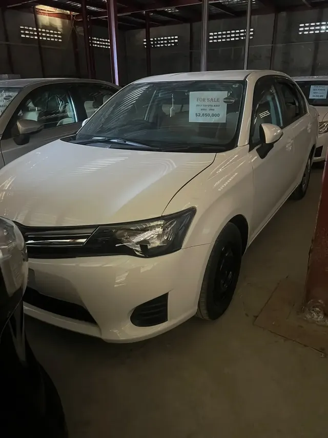 2013 Toyota Corolla Axio, white sedan for sale at Rahaman & Sons, Success — in stock
