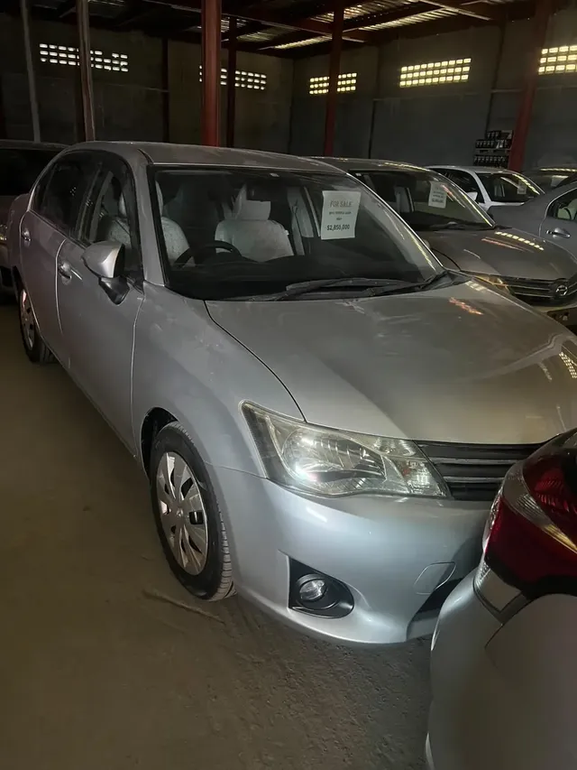 2013 Toyota Corolla Axio, silver sedan for sale at Rahaman & Sons, Success — in stock