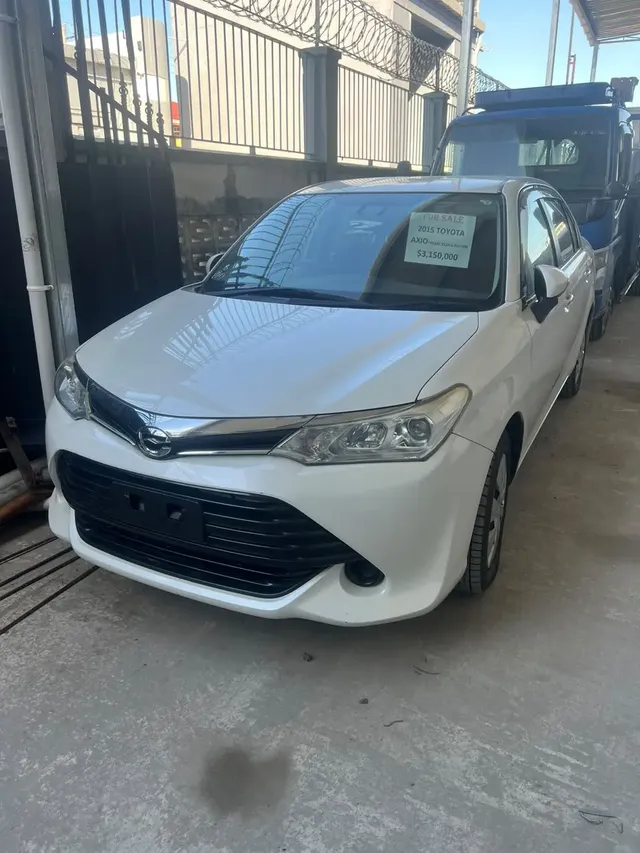 2015 Toyota Corolla Axio, white sedan for sale at Rahaman & Sons, Success — in stock